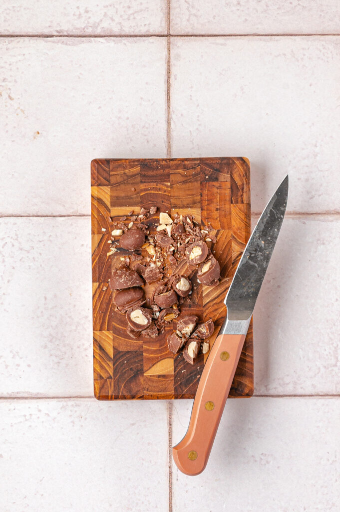 chopped peanut butter cups on a wooden board