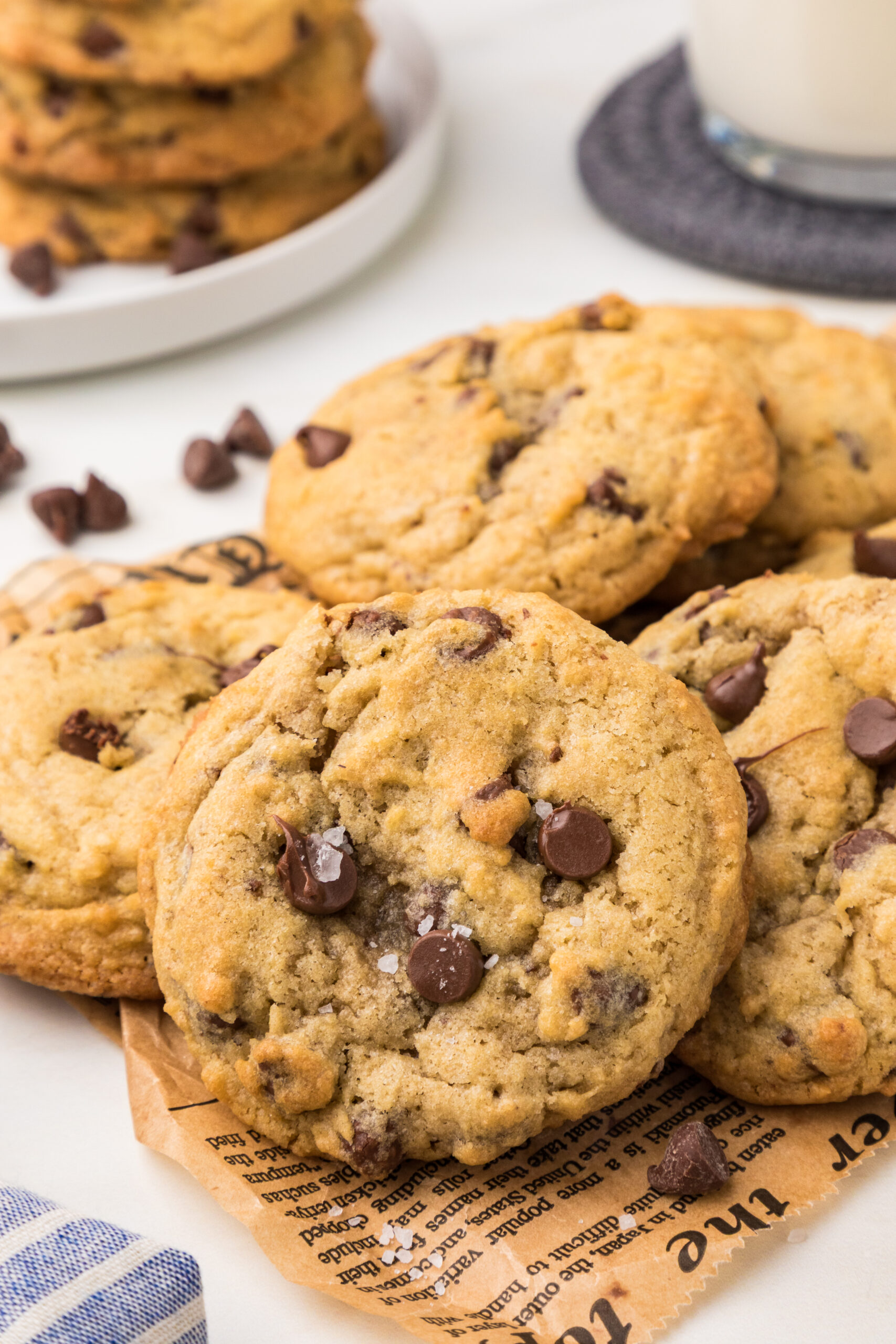 ⭐ ALT TEXT Soft and chewy chocolate chip cookies with golden edges and melty chocolate chips on a baking tray.