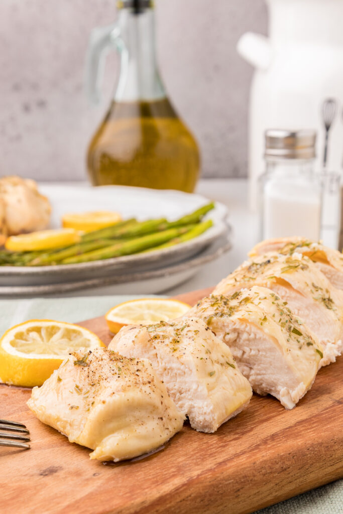 sliced breast chicken on a wooden board
