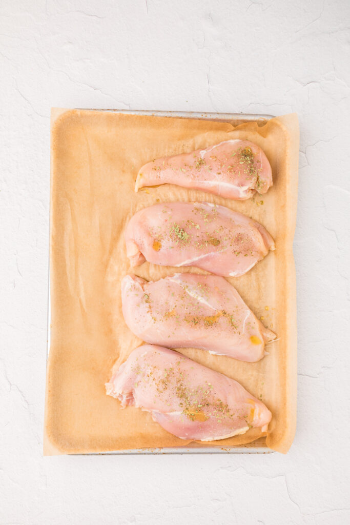 chicken on a sheet pan with parchment paper