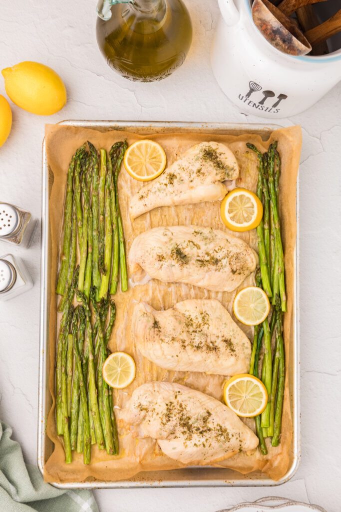 chicken asparagus and lemons on a sheet pan