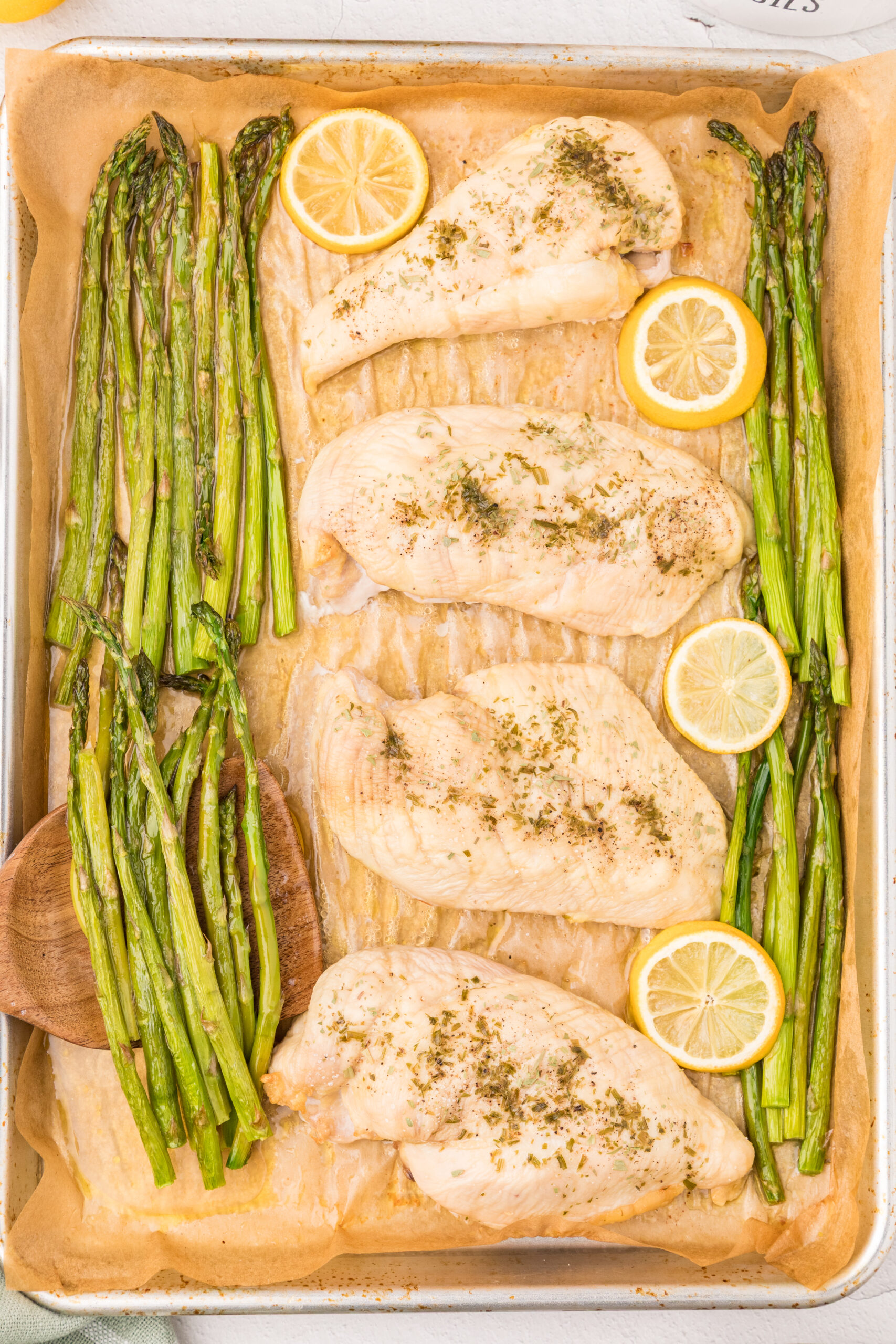 Chicken breast with lemon and asparagus on a sheet pan