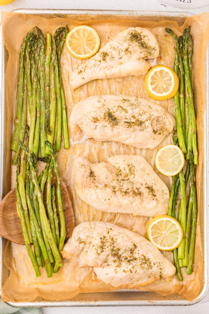 Chicken with asparagus and lemons on a sheet pan